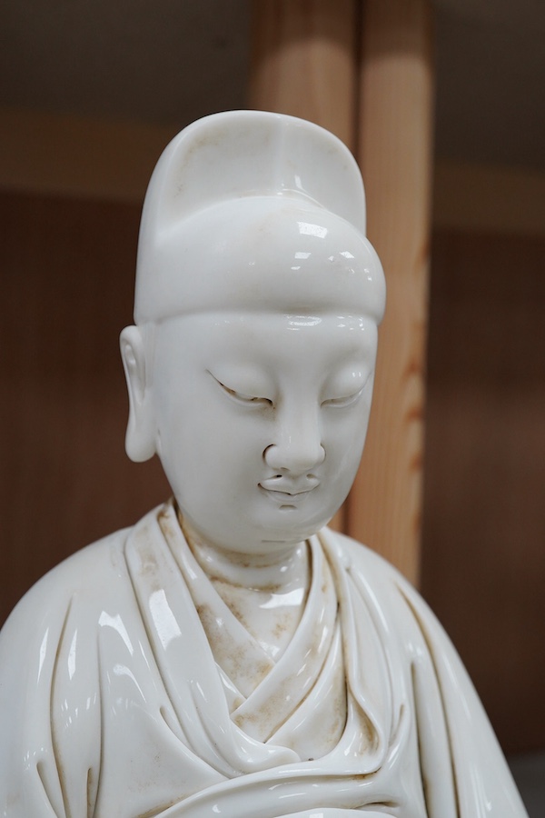 A Chinese white glazed pottery figure of Wenchang Wang, 37cm high. Condition - good